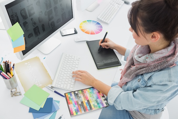 Artist drawing something on graphic tablet at office